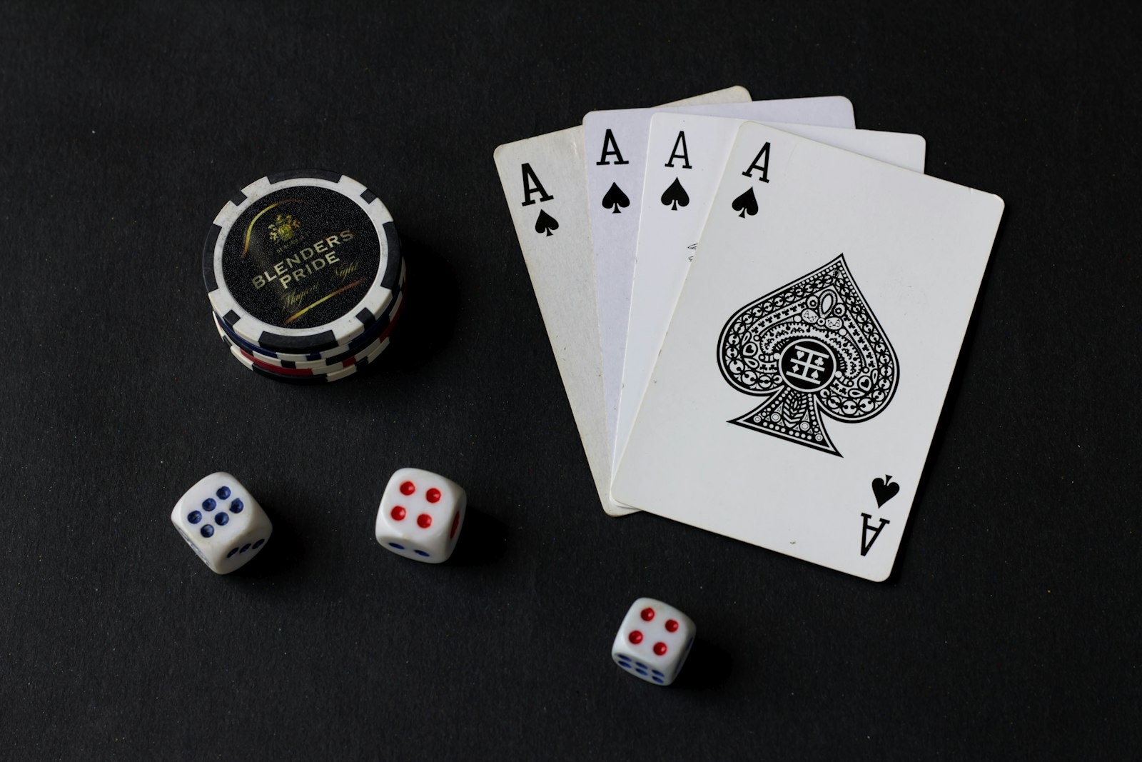 Playing cards and dice arranged on a dark table
